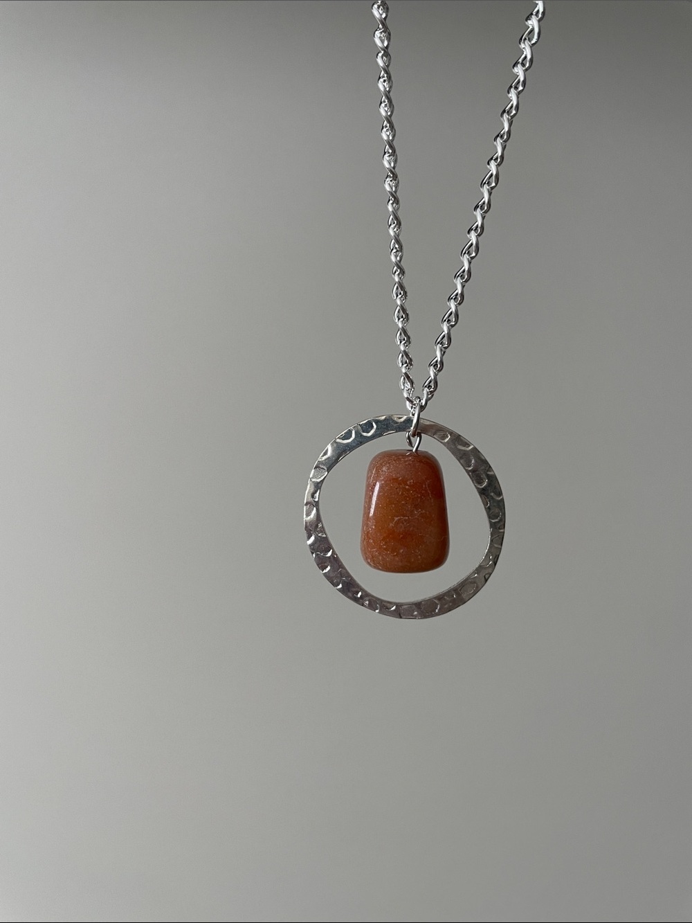 Hanging orange speckled rectangular stone necklace